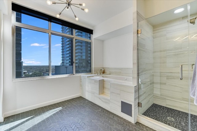 bathroom with tile patterned floors, shower with separate bathtub, and a chandelier