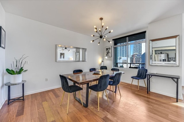 dining room featuring hardwood / wood-style flooring and a chandelier