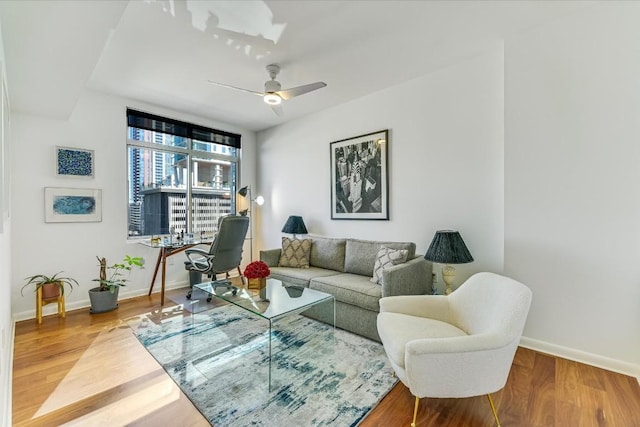 living room with ceiling fan and hardwood / wood-style floors