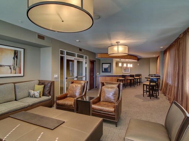 living room with light colored carpet, french doors, and wood walls