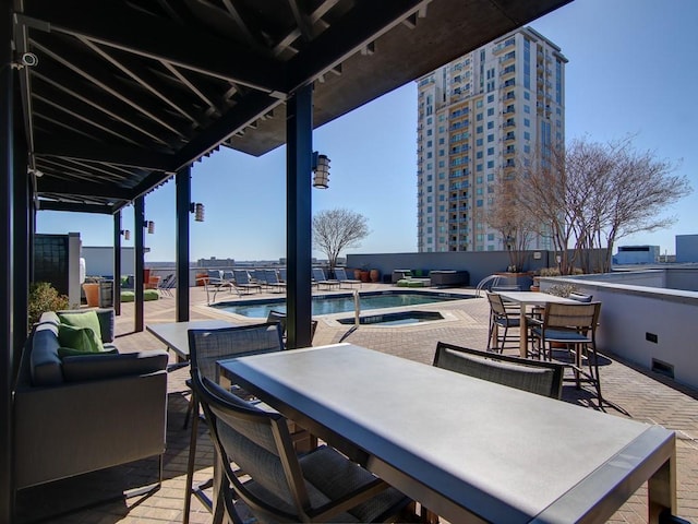 view of patio with a swimming pool with hot tub