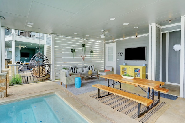 living room featuring concrete flooring and ceiling fan