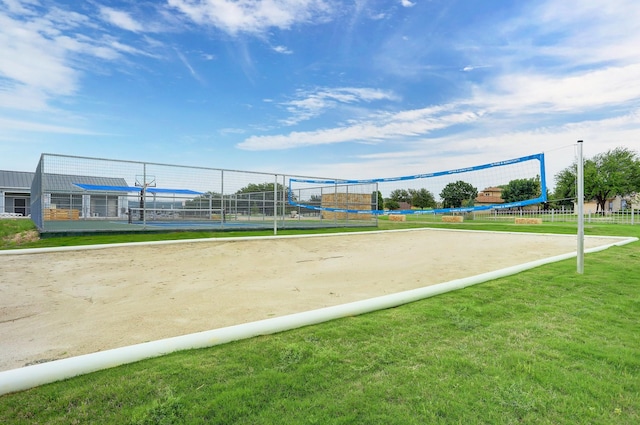 surrounding community with a yard and volleyball court