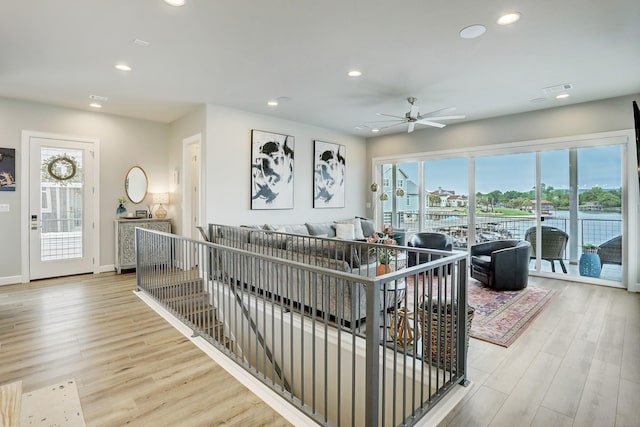 living room featuring ceiling fan and light hardwood / wood-style flooring