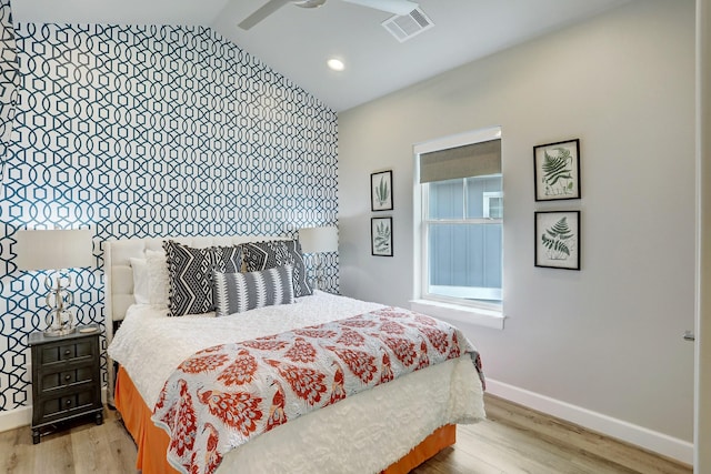 bedroom with lofted ceiling, light wood-type flooring, and ceiling fan