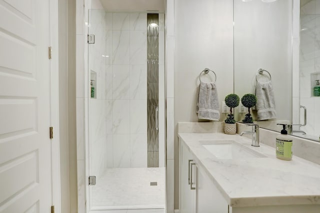 bathroom featuring vanity and a shower with door