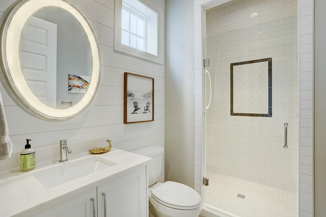 bathroom with vanity, toilet, an enclosed shower, and wood walls