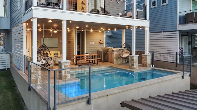 view of swimming pool with a patio area and an outdoor kitchen