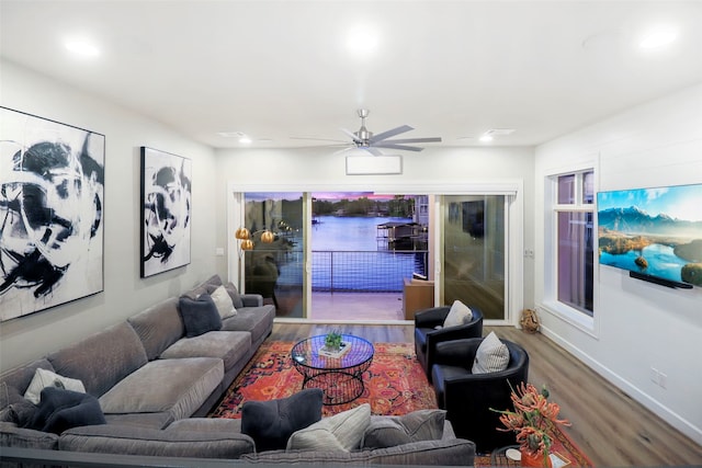 living room with hardwood / wood-style flooring and ceiling fan