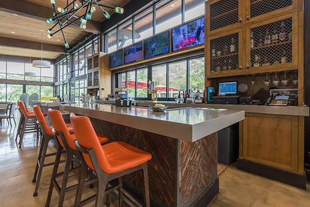 404 Eagle Dr, San Marcos, TX 78666 - bar area featuring finished concrete floors, a high ceiling, healthy amount of natural light, decorative light fixtures, and beamed ceiling
