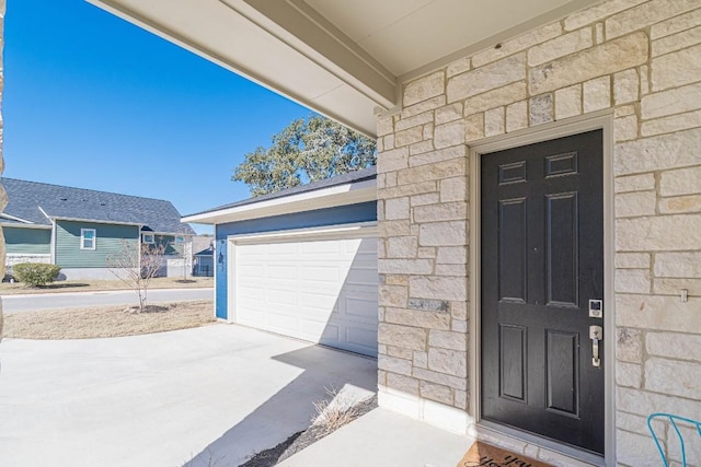 404 Eagle Dr, San Marcos, TX 78666 - entrance to property with driveway, a garage, and stone siding