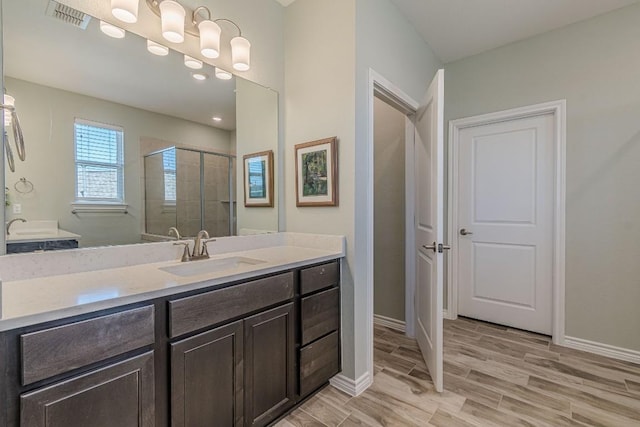 404 Eagle Dr, San Marcos, TX 78666 - full bathroom with a shower stall, vanity, and wood finished floors