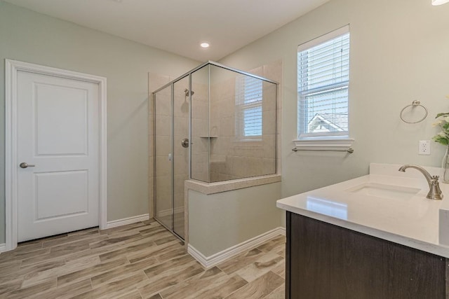 404 Eagle Dr, San Marcos, TX 78666 - bathroom featuring tiled shower, vanity, and wood finished floors