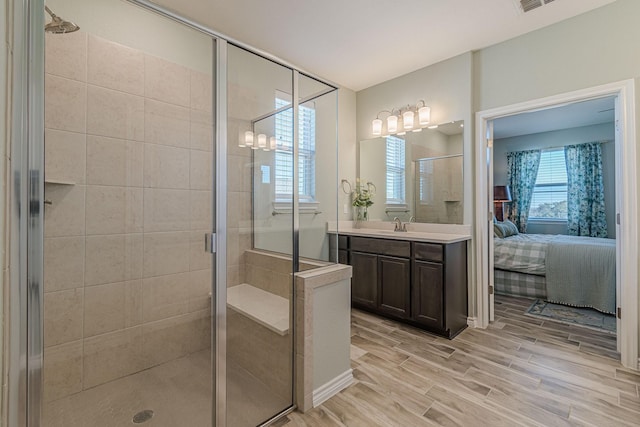 bathroom featuring walk in shower, vanity, and hardwood / wood-style floors