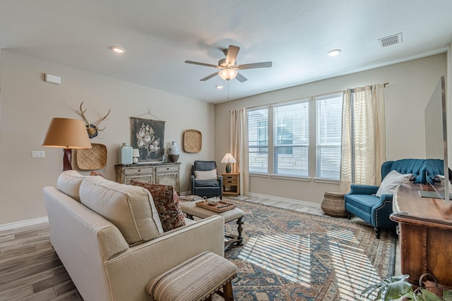 living room with hardwood / wood-style floors and ceiling fan