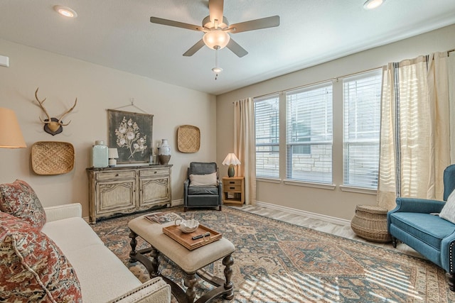 living room with hardwood / wood-style flooring and ceiling fan