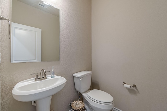 bathroom with toilet and sink