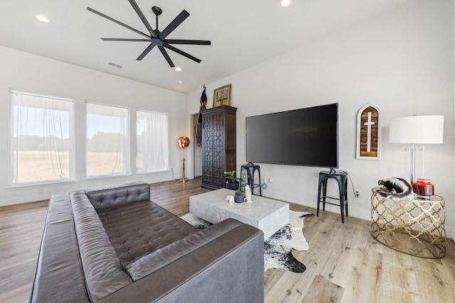 living room with ceiling fan, plenty of natural light, and light hardwood / wood-style floors