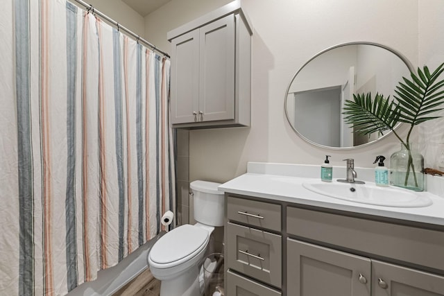 full bathroom featuring vanity, hardwood / wood-style floors, shower / bath combination with curtain, and toilet