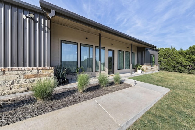 rear view of house featuring a patio and a yard