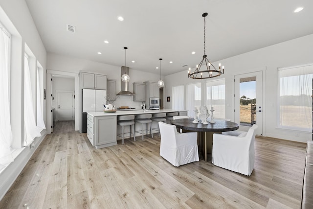 dining space featuring sink and light hardwood / wood-style floors