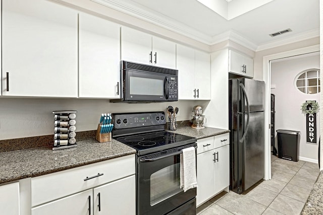 kitchen featuring crown molding, white cabinetry, dark stone countertops, black appliances, and light tile patterned flooring