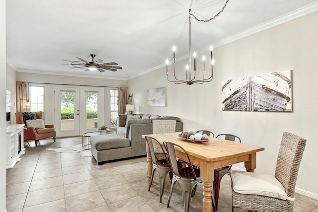 tiled dining space featuring crown molding, ceiling fan, and french doors