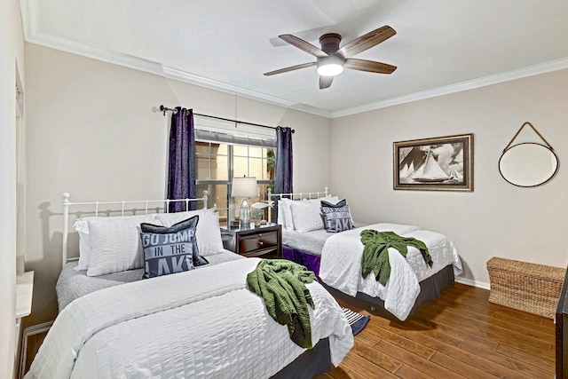 bedroom featuring crown molding, hardwood / wood-style flooring, and ceiling fan