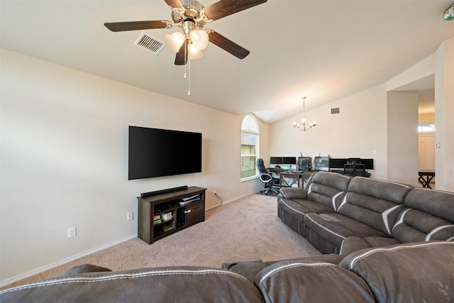 living room with vaulted ceiling, ceiling fan with notable chandelier, and light colored carpet