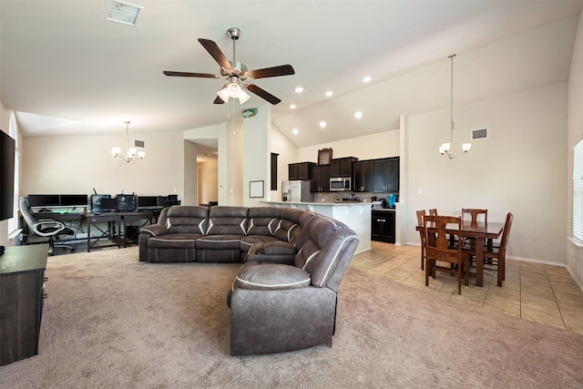 living room with lofted ceiling, light tile patterned floors, and ceiling fan with notable chandelier