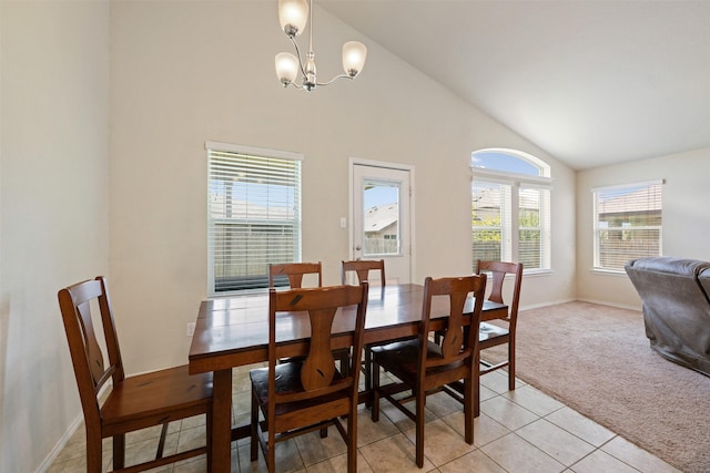 dining area with light colored carpet, a chandelier, and high vaulted ceiling