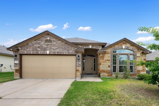 view of front of property featuring a garage and a front yard