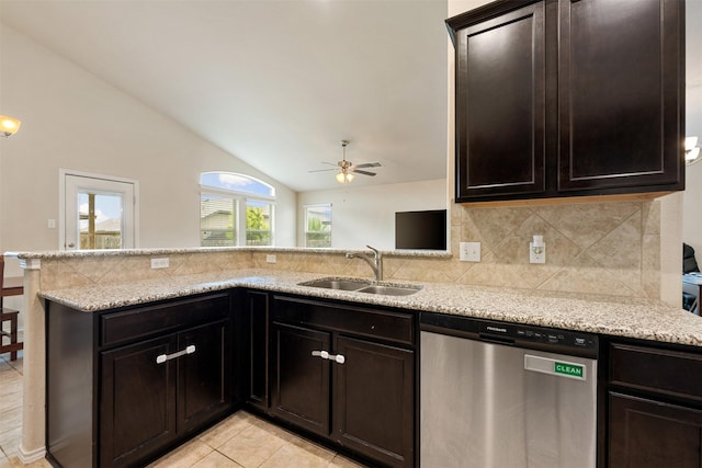 kitchen featuring lofted ceiling, sink, stainless steel dishwasher, light stone counters, and kitchen peninsula