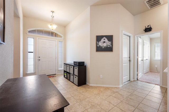 foyer entrance featuring light tile patterned flooring