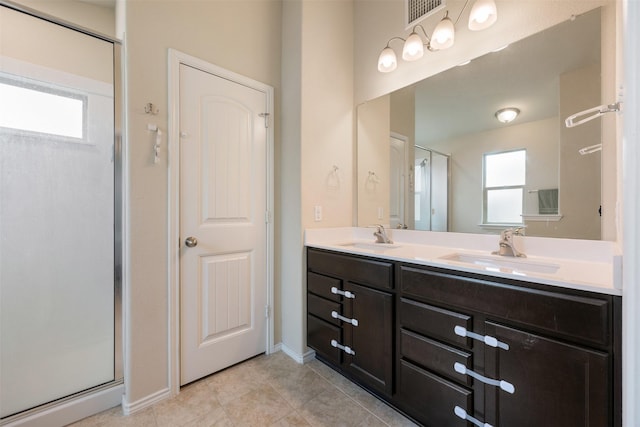 bathroom featuring vanity, tile patterned flooring, and a shower with door