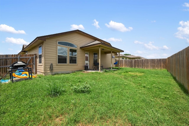 rear view of property with a yard