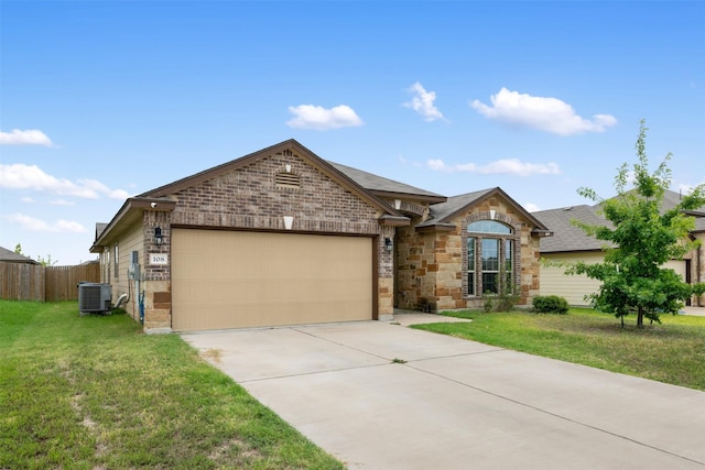 ranch-style home featuring a garage, central AC, and a front lawn