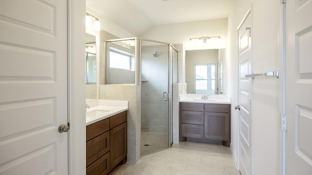 bathroom featuring tile patterned flooring, vanity, plenty of natural light, and walk in shower