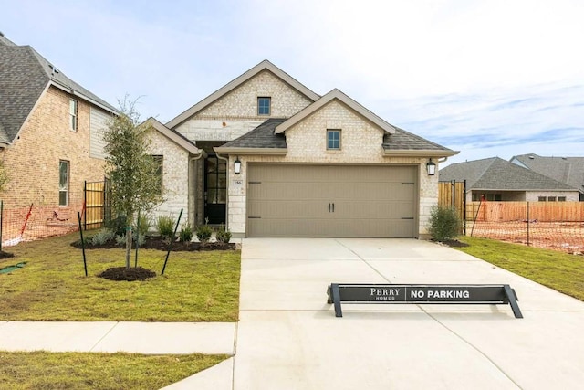 view of front of home featuring a garage and a front lawn