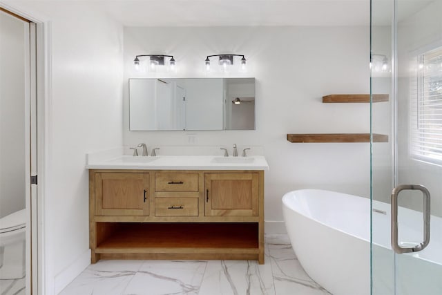 bathroom with vanity, a tub, and toilet