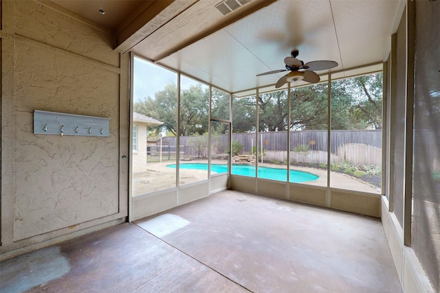 unfurnished sunroom featuring ceiling fan and a wealth of natural light