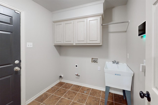 washroom featuring sink, cabinets, dark tile patterned flooring, washer hookup, and hookup for an electric dryer