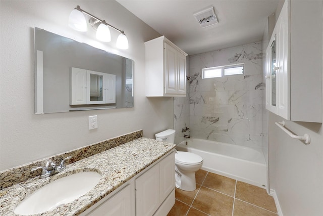 full bathroom featuring vanity, tile patterned flooring, toilet, and tiled shower / bath