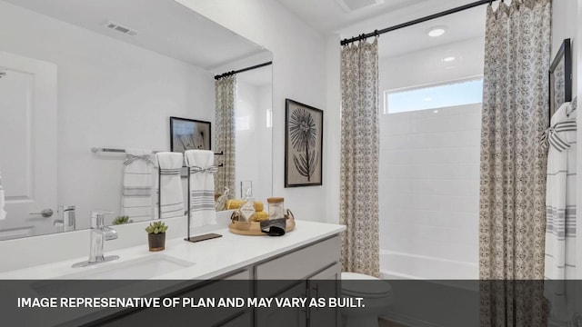 full bathroom featuring vanity, shower / bath combination with curtain, and toilet