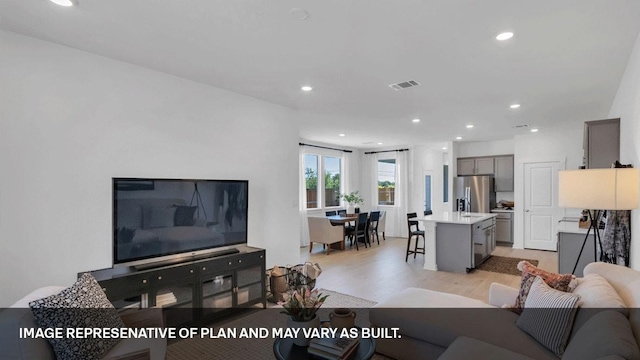 living room with light hardwood / wood-style flooring