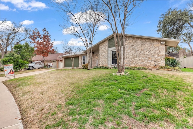 tri-level home featuring a garage and a front yard