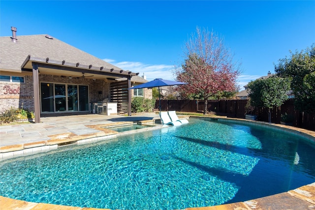 view of swimming pool with a patio area and an in ground hot tub