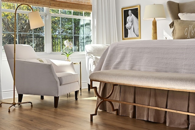 bedroom with wood-type flooring and multiple windows