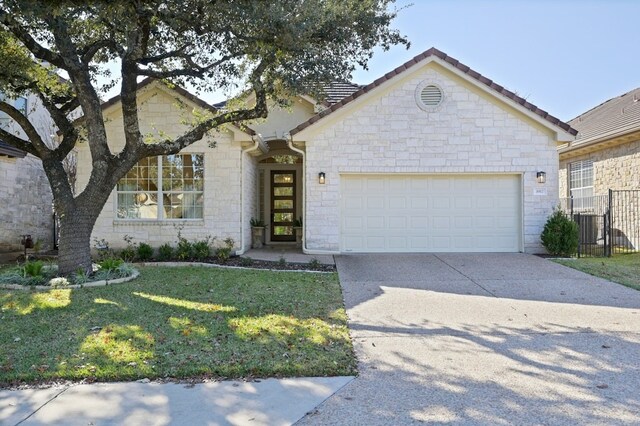 view of front of home with a garage and a front yard