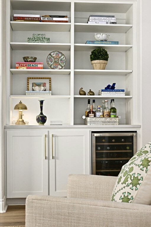 bar with wood-type flooring, wine cooler, and built in shelves